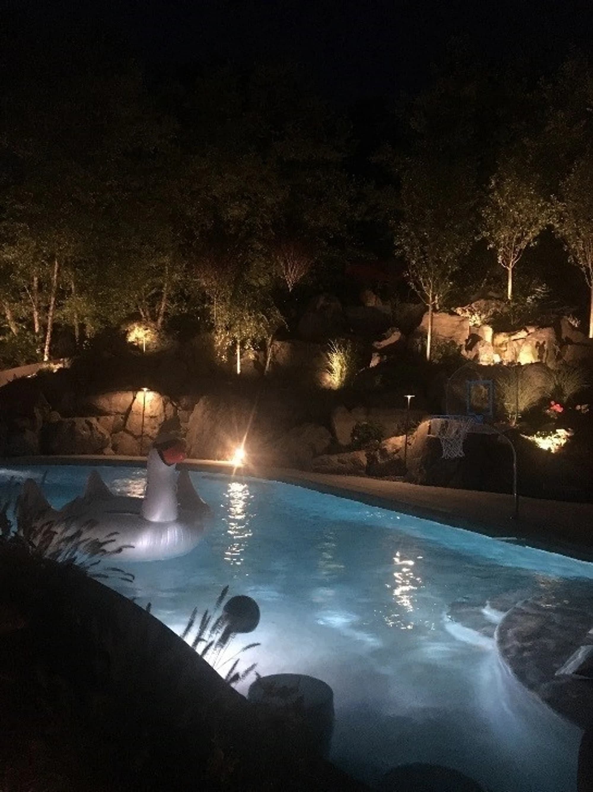 A Connecticut pool wired and lit by Priority Electric at night